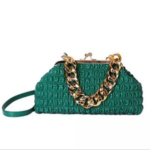 Large size women's handbag with gold chunky chain handle.